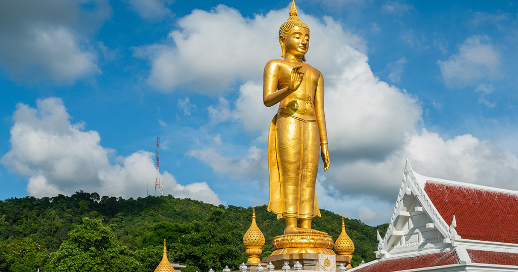 Golden standing Buddha at the peak at Hat Yai
